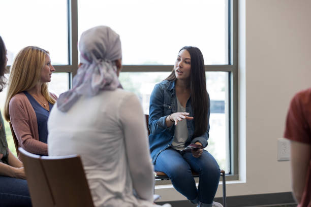 istock Serious woman discusses something during group therapy session 1171197291