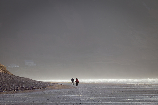 Couple walking on the Rossbeigh Beach