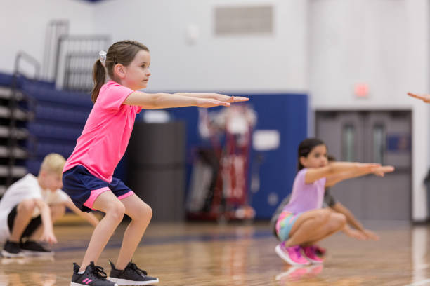 istock Little girl doing squats in PE class 1171197377