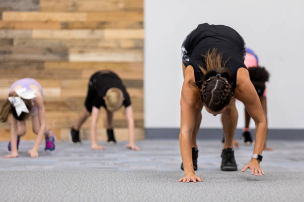 istock Fitness instructor leads class for children 1171197388