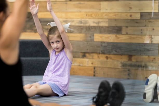 istock Little girl stretches during PE class 1171197472