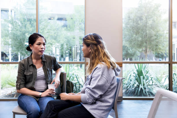 istock Female veterans sit apart from group and share their stories 1171197664