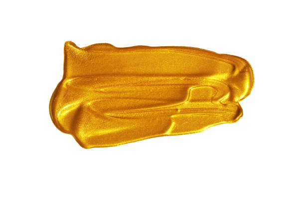 Gold colored metallic paint, brush stroke make-up, isolated on white close up with copy space, no people