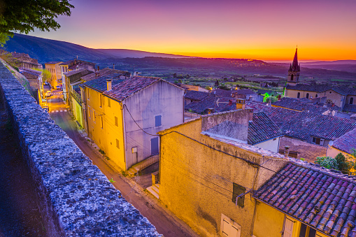 Town of Bonnieux at early dawn with a view of the agricultural countryside in Provence, France