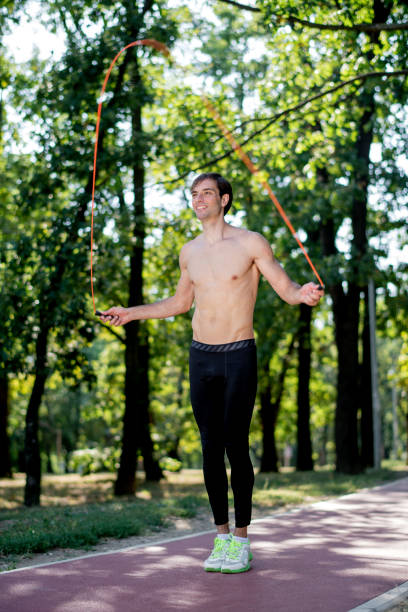 istock Young man exercising jumping rope in nature 1171204584