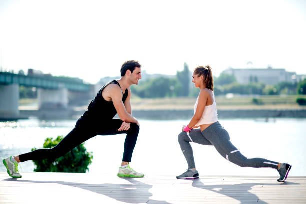 istock Young man and young woman exercising together 1171205551
