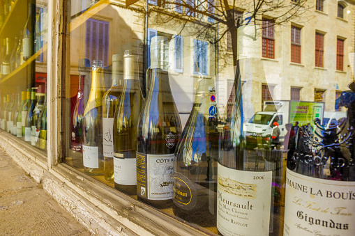 The French region of Provence on April 05, 2014:Wine store window in the town of Apt selling locally produced wines in Provence, France