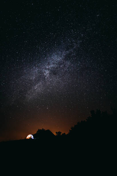 istock Camping at night in the mountains under starry sky 1171206683