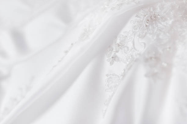 Bride's dress with embroidered elements and beads. Bridal traditional symbolic accessory for wedding ceremony.