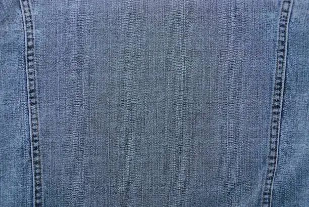 Photo of fabric background  of a piece of cotton clothing with a seam