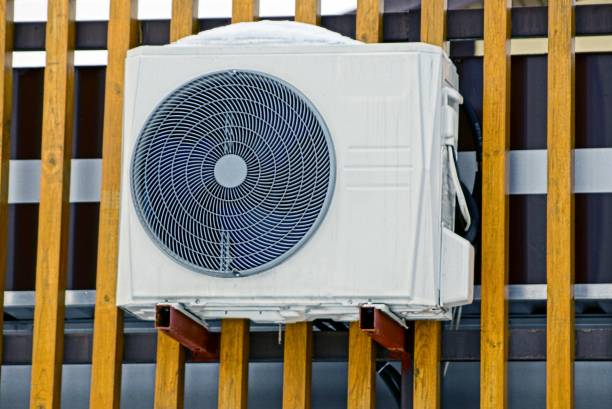 istock one gray air conditioner on a brown wooden wall 1171207447