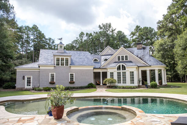istock Custom pool House behind an estate with a large swimming pool 1171207588