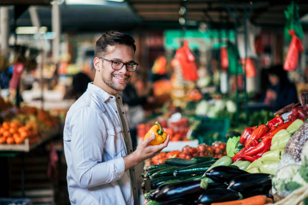 istock Millenial man buying vegetables. 1171209822