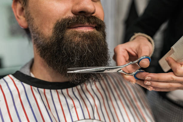 istock Barber grooming client's beard, close-up. 1171209877