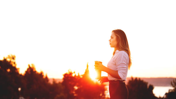 istock young woman and coffee break at sunset 1171212808