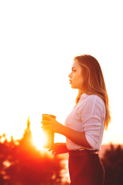 istock young woman and coffee break at sunset 1171212815