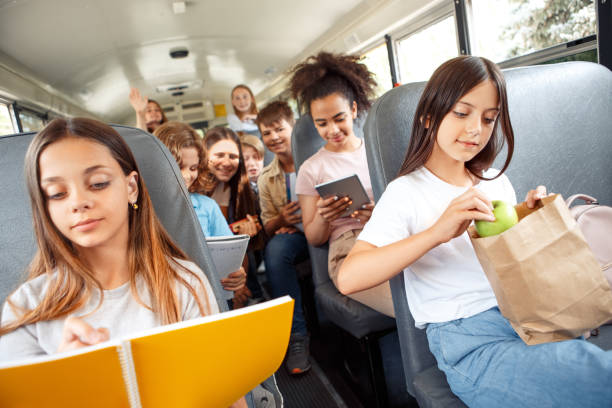 istock Classmates going to school by bus sitting doing their things concentrated joyful 1171218017