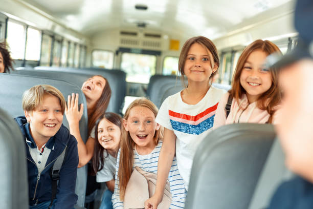 istock Classmates going to school by bus sitting inside talking to driver cheerful 1171218018