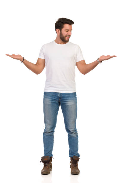 istock Smiling Man Is Standing With Hands Raised And Comparing. Front View. 1171218738