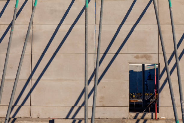 Construction site scene with props holding up new concrete wall stock photo