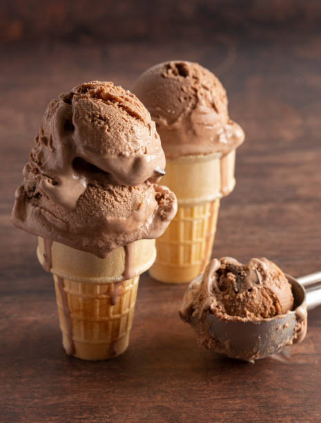 istock Chocolate Ice Cream Cone on a Rustic Wooden Table 1171222290
