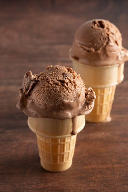 istock Chocolate Ice Cream Cone on a Rustic Wooden Table 1171222306