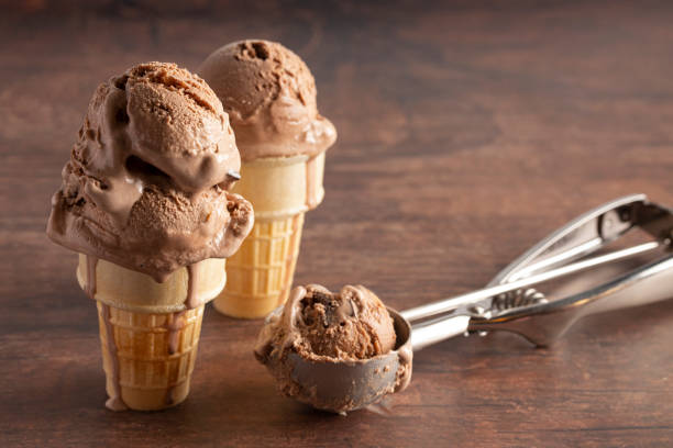 istock Chocolate Ice Cream Cone on a Rustic Wooden Table 1171222349