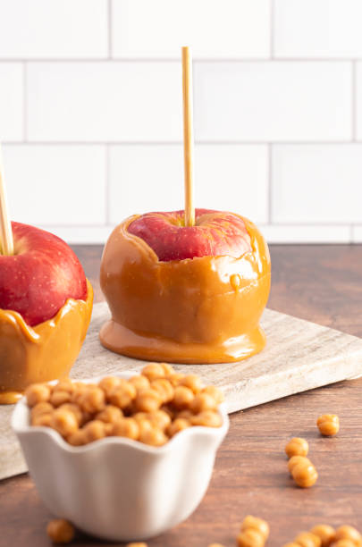 istock Beautiful Caramel Apples on a Rustic Kitchen Cabinet Ready for Fall 1171222529