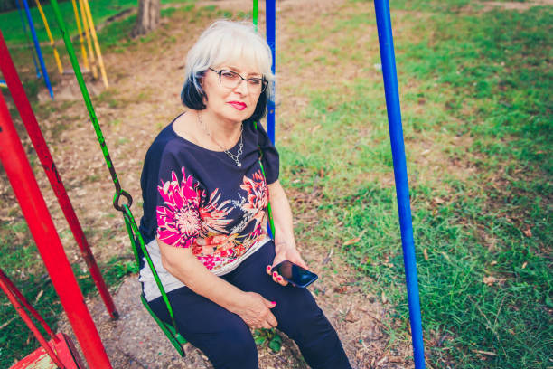 istock Senior Woman sitting on swing. 1171230395