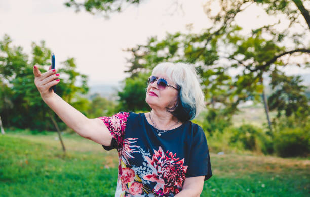 istock Modern Senior Woman taking selfie 1171230401