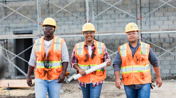 istock Woman leading workers at construction site 1171238918
