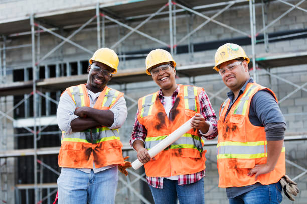 istock Woman leading workers at construction site 1171238952
