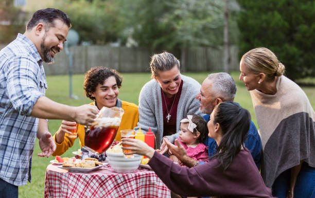 istock Multi-generation Hispanic family having backyard cookout 1171240574