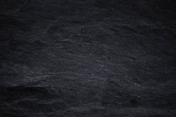 istock Dark grey black slate background or natural black stone texture 1171241595