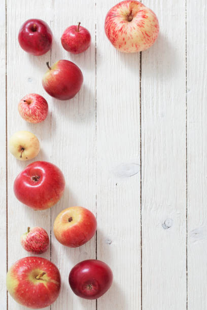 istock apples on wooden white background 1171245755