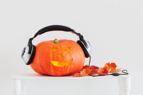 istock Halloween pumpkin with headphones on white background 1171245776