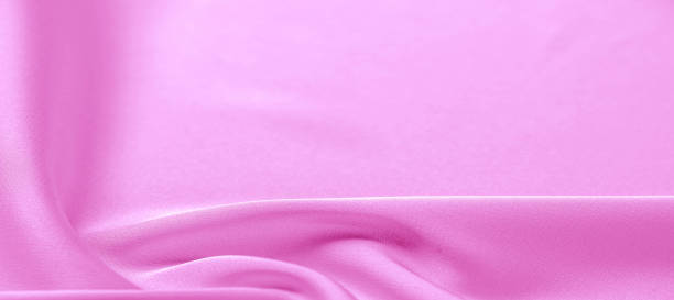 istock texture. Pink silk fabric. brilliant luster and characteristic small blinds that run horizontally throughout the fabric It falls into soft folds when draped and is the most versatile fabric we carry 1171249786
