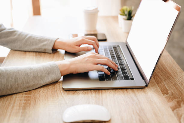 istock Asian woman using computer laptop for working on wooden table 1171250914