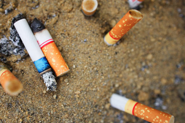 Used cigarettes are abandoned on sand