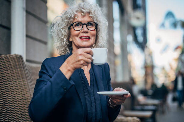 istock Beautiful senior woman drinking a hot drink 1171254382