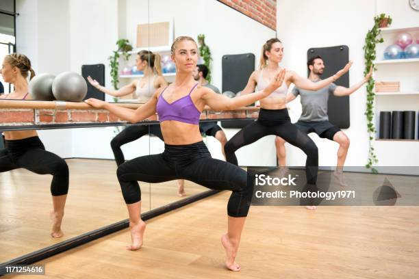 Group Of People Performing Second Position Plie Stock Photo - Download Image Now - Barre, Exercising, Healthy Lifestyle