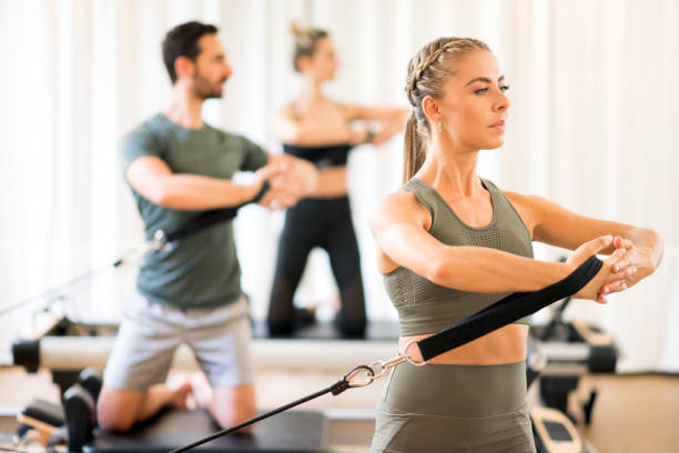 istock People exercising torso rotation at gym 1171254653