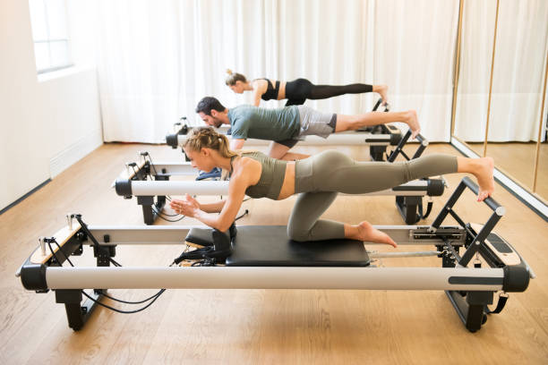 istock Friends doing pilates kneeling glutes exercises 1171254675