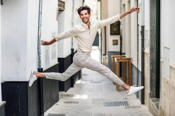 istock Young happy man jumping in the street. 1171258849