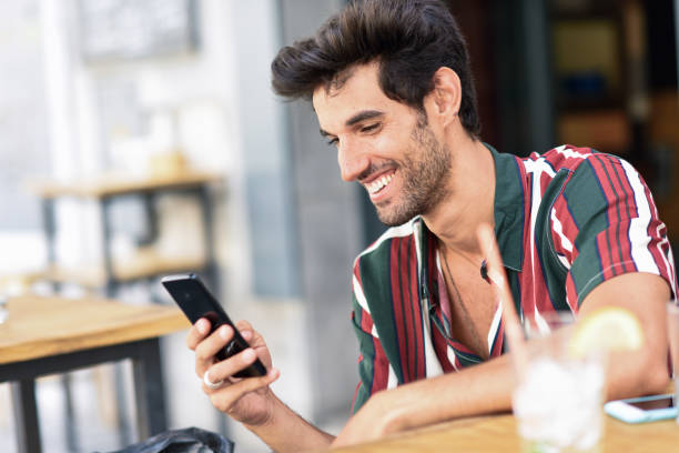 istock Young man using smartphone in an urban cafe. 1171258870