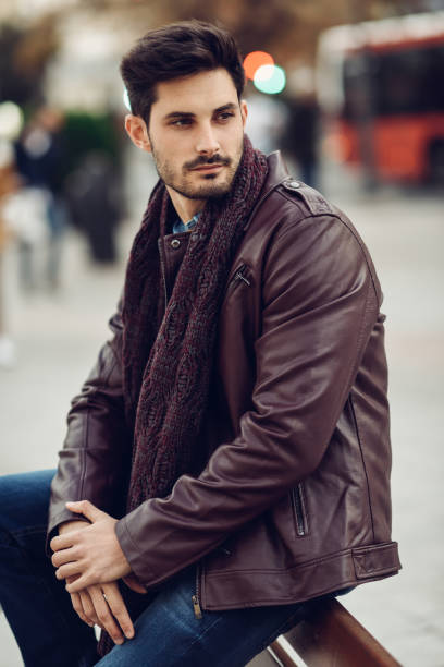 istock Thoughtful young man sitting on an urban bench. 1171258936
