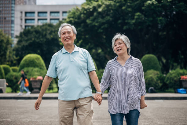 istock Senior couple walking in park 1171259697