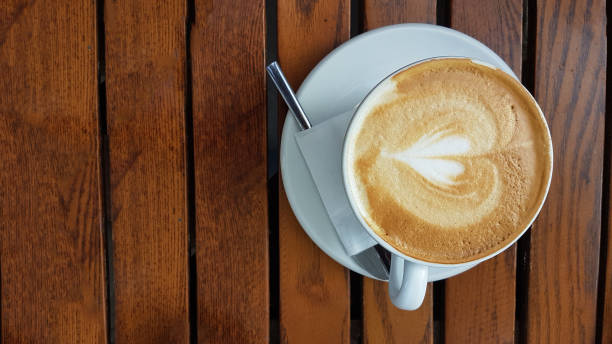 istock coffee cappuccino on wooden table background isolated 1171262190