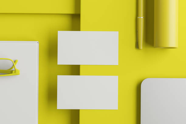 istock Two blank business cards on yellow office table 1171263963