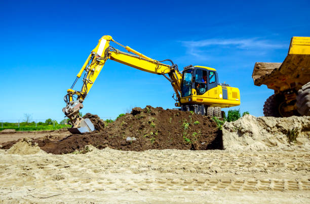 istock Excavator is loading a truck with ground on building site 1171265438